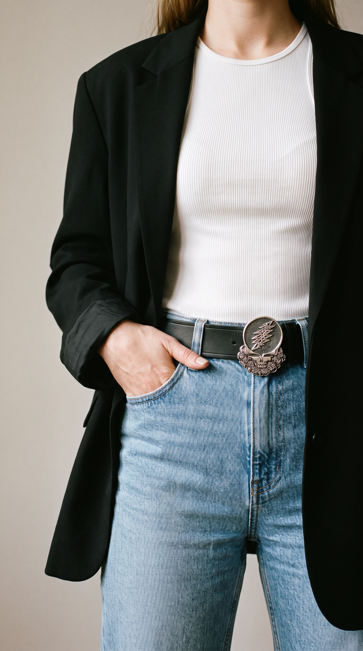 Steal Your Face sterling silver belt buckle worn on a black leather belt with jeans, white tank top and black blazer - Grateful Dead limited edition by Cynthia Gale New York (mobile)